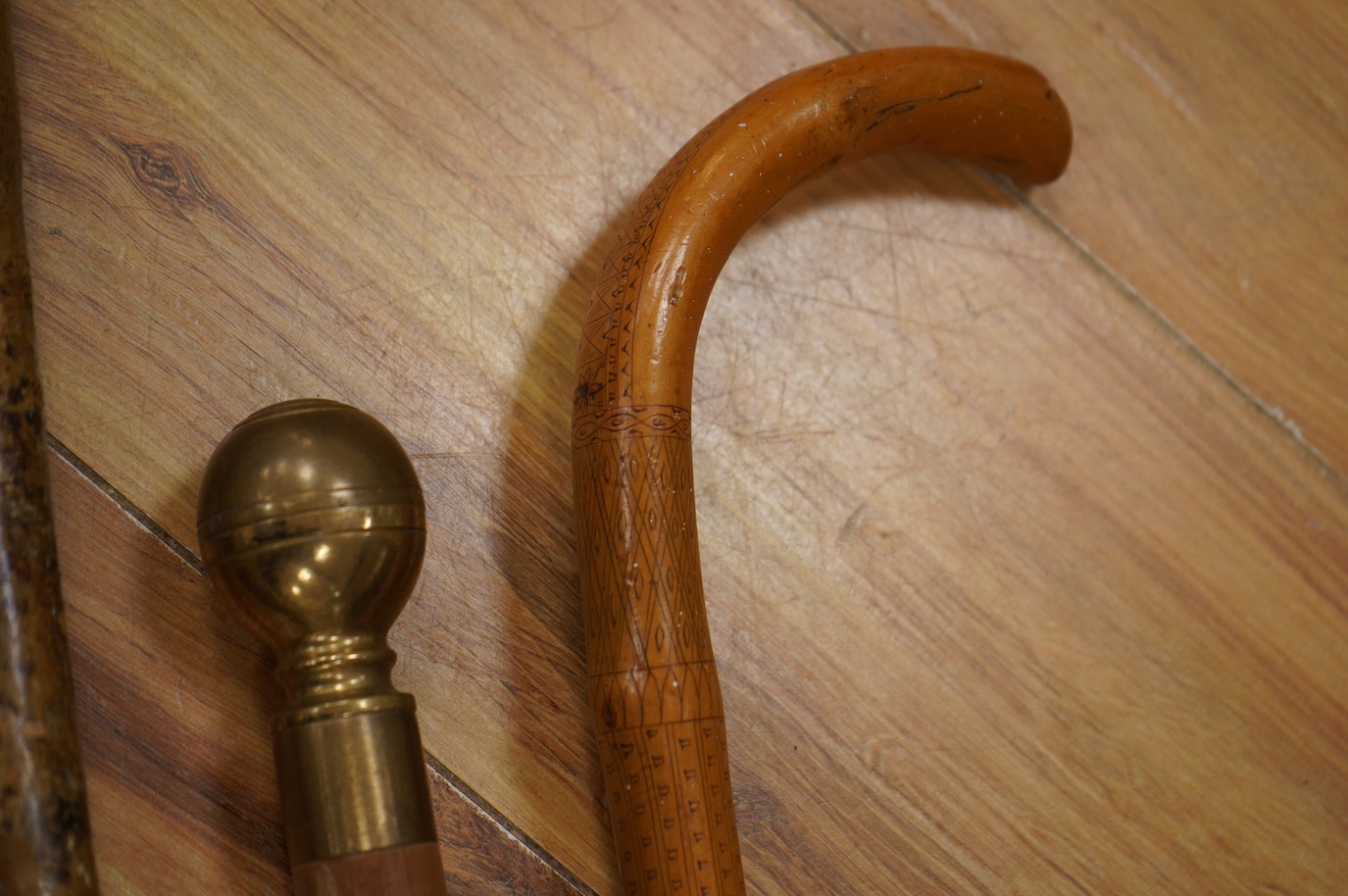 Three novelty walking sticks and gouged gathering bowl. Condition - fair